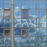 Reflections Blue Clouds on an Office Block / Photograph