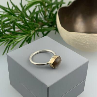 Peach Moonstone set in 9ct gold in a silver ring