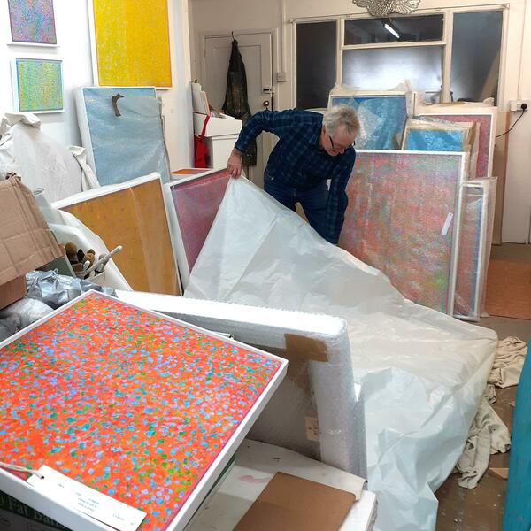 wrapping up paintings for exhibition.