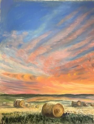 Round bales at sunset